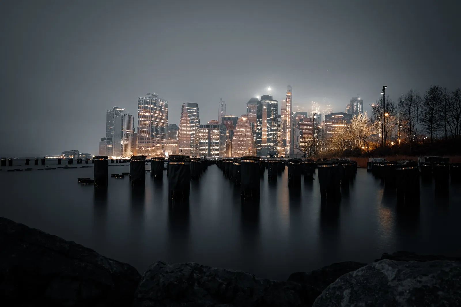 A city skyline seen from the water at night