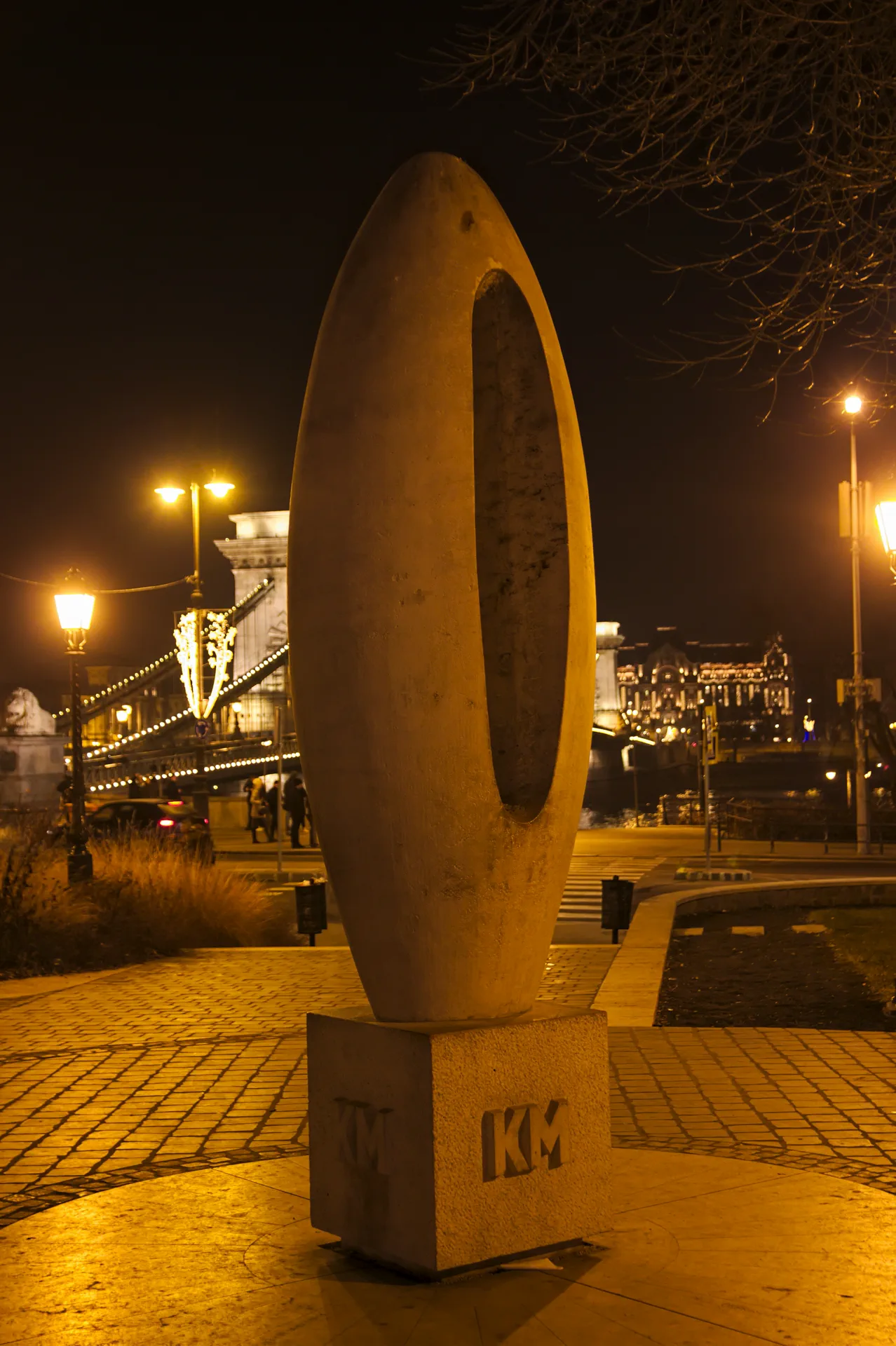 Zero Kilometre Stone beside the illuminated Chain Bridge at night