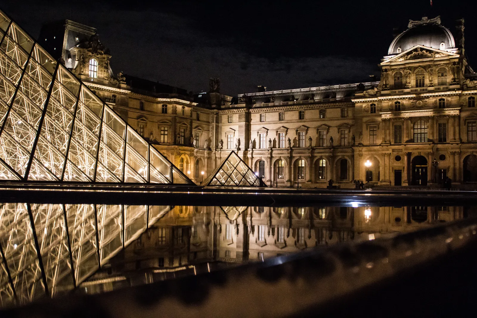 The Louvre pyramid illuminated in Paris at night