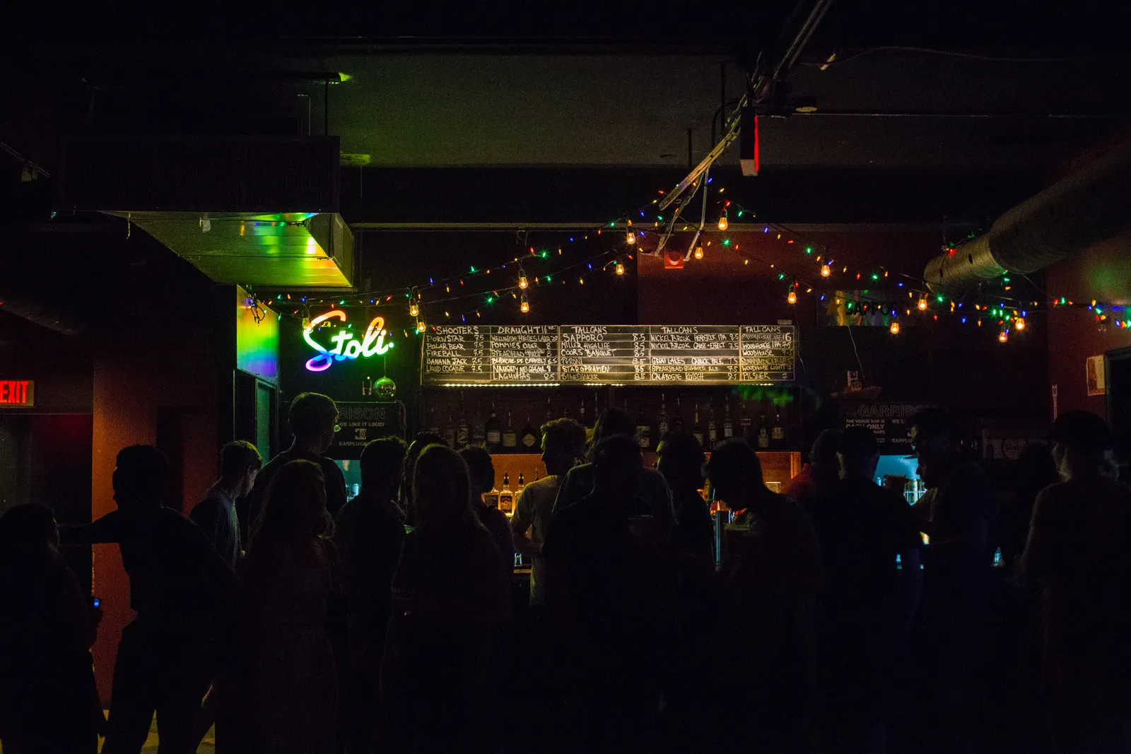 A lively nightlife crowd inside a bar after dark