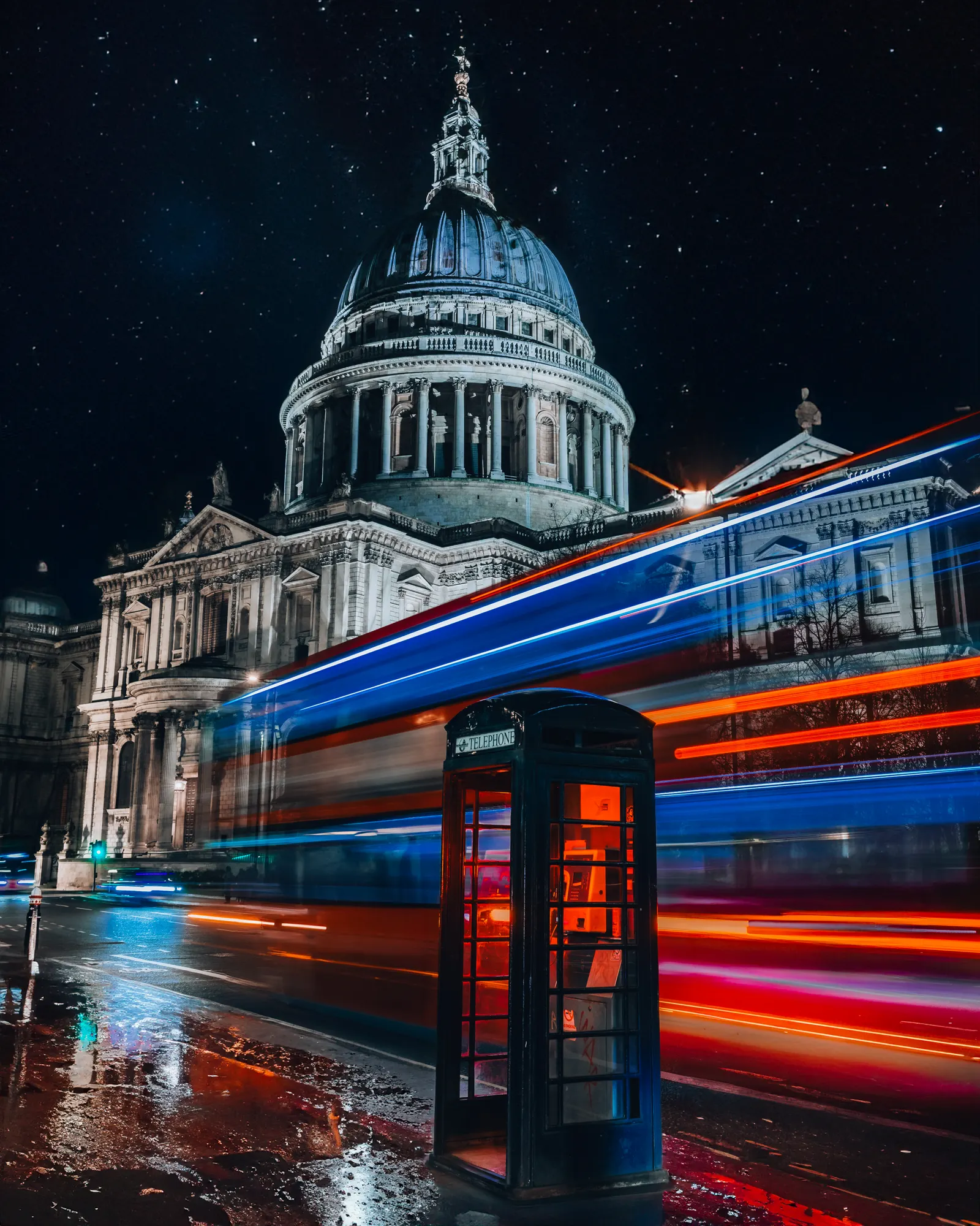 St Pauls Cathedral rising beyond a London street lit at night