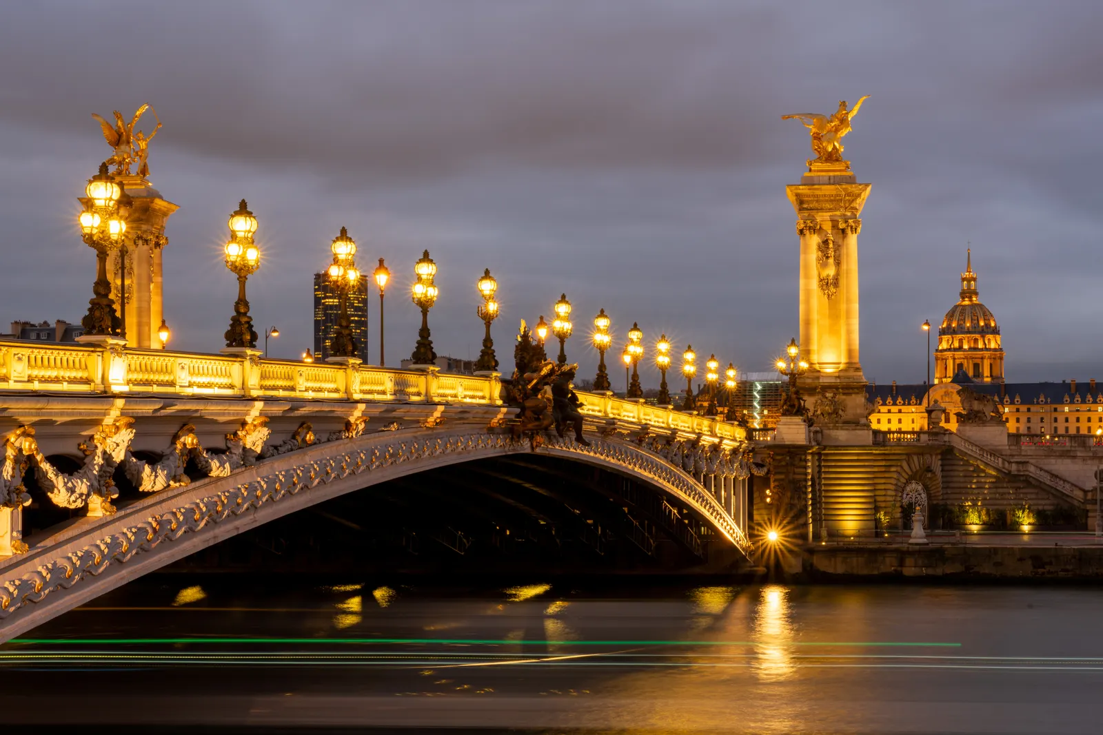 Paris lights reflected across the Seine at night