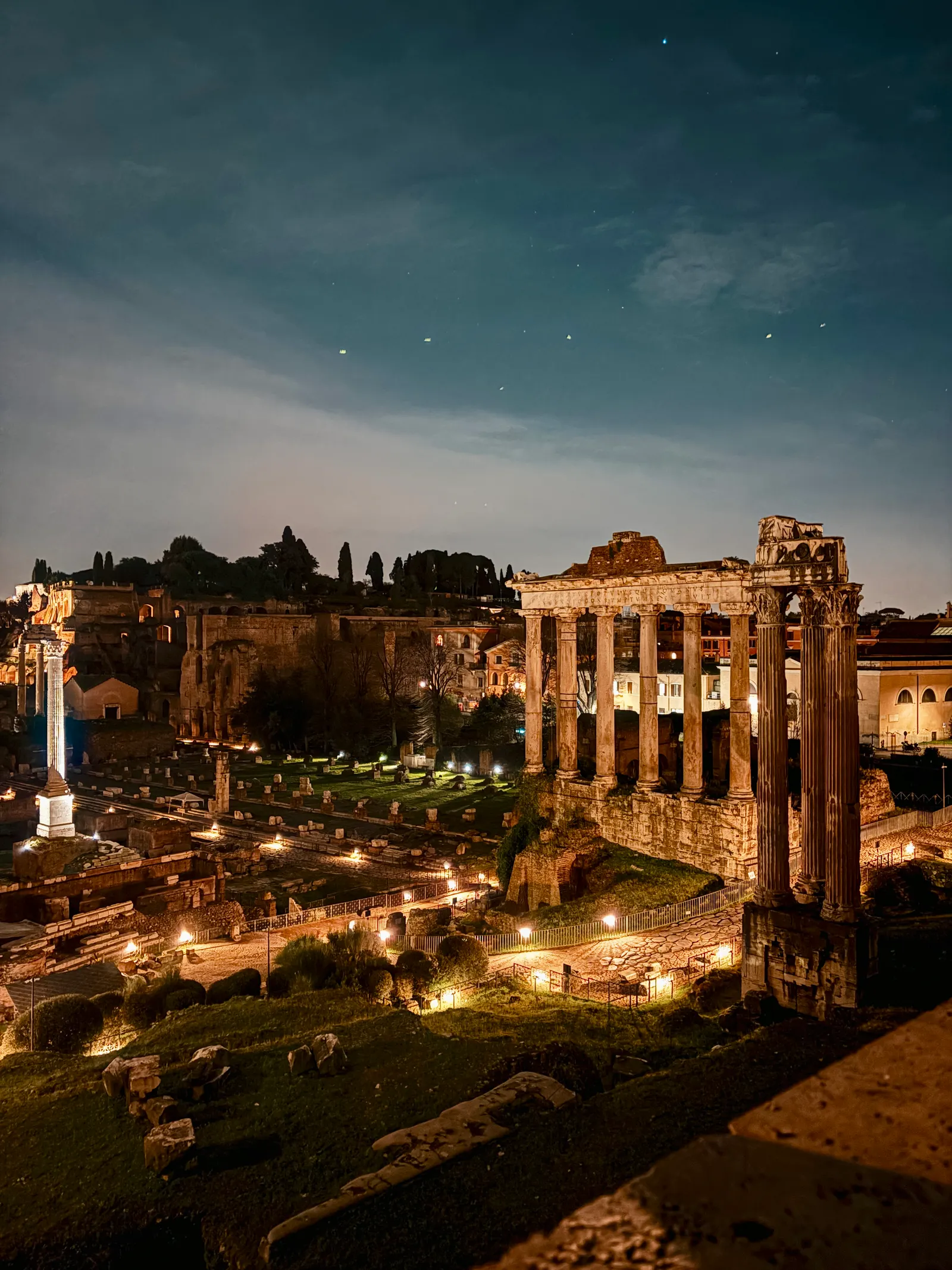 The Roman Forum glowing under night lighting